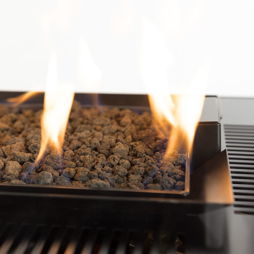 Close-up of flames over lava rocks in a commercial patio heater