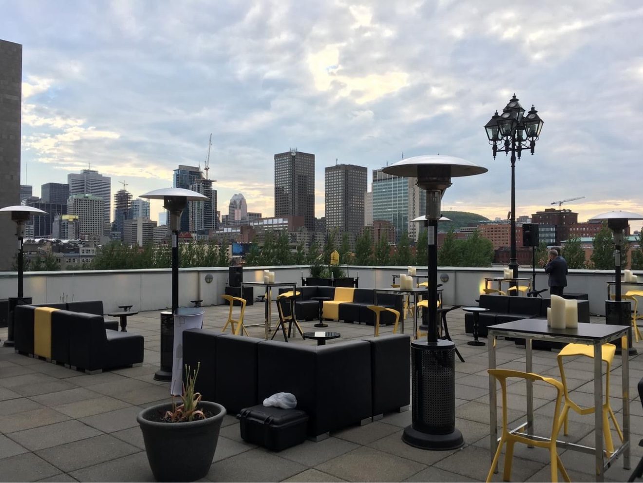 Sunglo mushroom patio heaters on a rooftop terrace with the Montreal skyline behind them